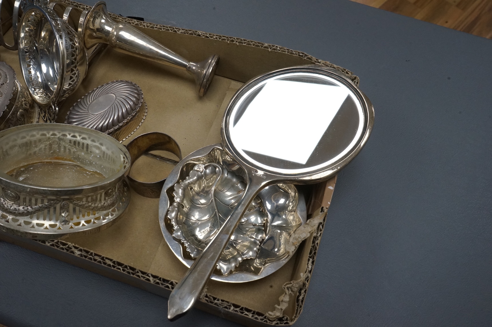 A group of small collectable silver including a late Victorian heart shaped trinket box, Chester, 1899, length 92mm (a.f.), a coaster, toast rack, spill vase, small trinket box, a pair of two handled dishes, napkin ring,